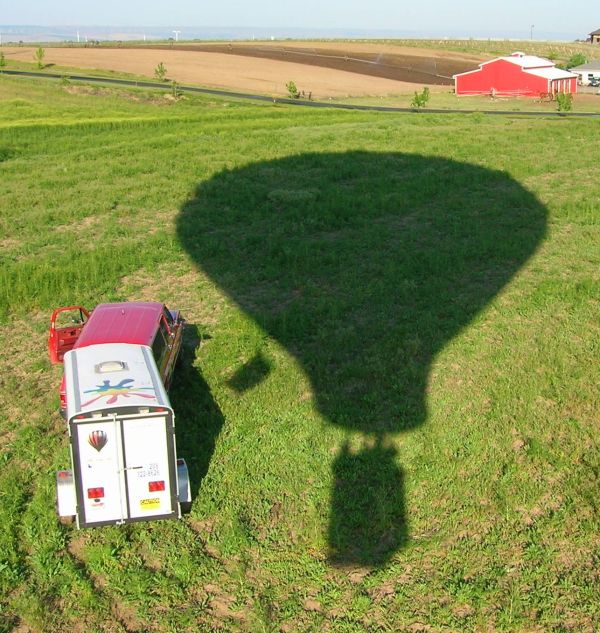 Balloon shadow in green field